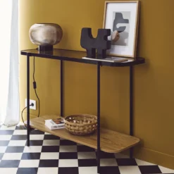 sweeek Consolle vintage in metallo nero con piano in vetro e decori in legno, 110 cm