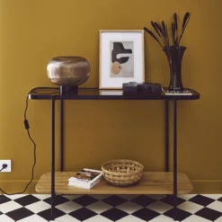 sweeek Consolle vintage in metallo nero con piano in vetro e decori in legno, 110 cm